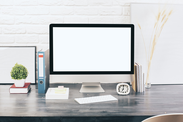 Creative designer desktop with blank white computer monitor, keyboard, stationery items, decorative plants and blank picture frames on white brick wall background. - Zdjęcie, obraz