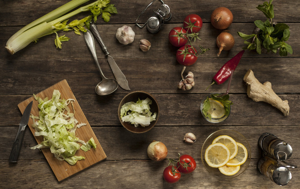 cabbage, tomatoes, garlic and onions on old wooden table - Фото, зображення