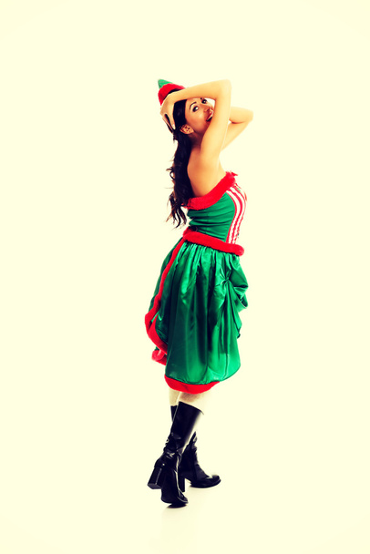 Woman wearing elf clothes holding her head - Foto, immagini