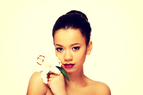Beauty face of woman with lily flower. - Fotografie, Obrázek