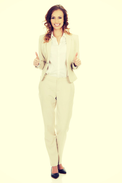 Businesswoman with thumbs up gesture. - Фото, изображение