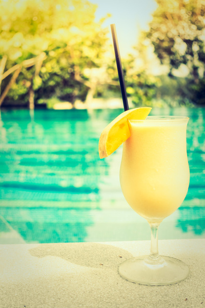 Mango juice with beautiful outdoor swimming pool - Photo, Image