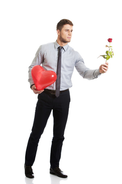 Man with red rose and heart balloon. - Foto, Imagen