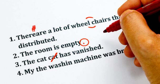 english sentences and correcting symbols on white sheet - Photo, Image