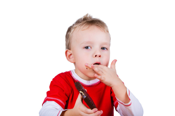 Small boy eating whole bar of chocolate - Foto, Bild
