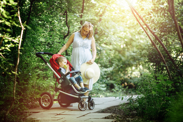 Woman walking with child in forest - Zdjęcie, obraz