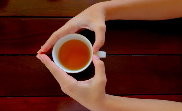 cup of tea in hand, top view - Foto, immagini