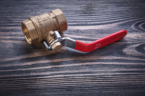 Full bore lever ball valve on wooden background plumbing concept - Foto, Imagen