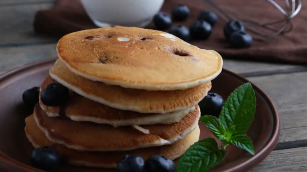 Blueberry pancakes on a plate pour maple syrup - Footage, Video