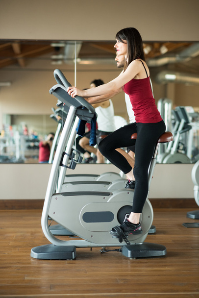 Woman working out on stationary bike - Foto, immagini