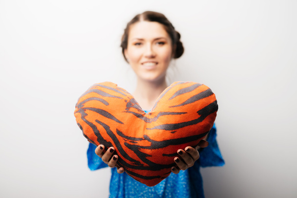 girl holding a toy heart - 写真・画像