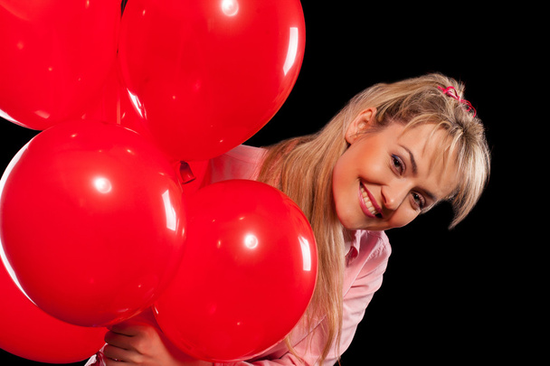 Pretty woman in blouse with red balloons - Foto, imagen