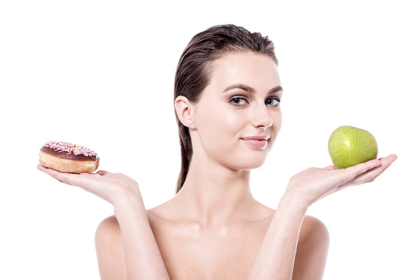 woman with green apple and donut - Photo, image