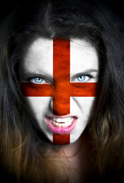 Portrait of a woman with the flag of the England  painted on her face - 写真・画像