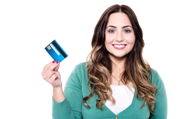 Cheerful woman showing credit card - 写真・画像
