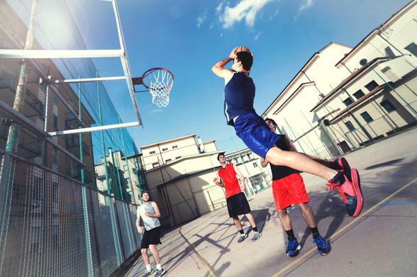 young basketball players playing with energy in a urban place - Foto, Imagem