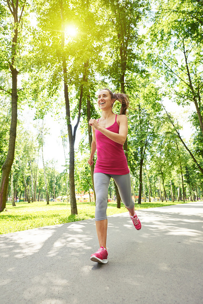  Graceful sporty woman jogging in the park - Foto, Imagen
