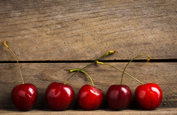 Cherry on wooden background - Photo, Image