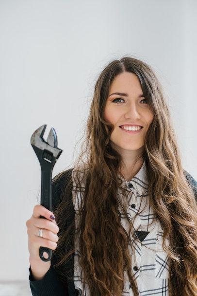 girl holding a wrench - Foto, imagen
