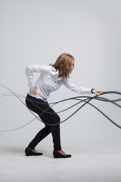 Woman with electrical cables or wires, curved lines - Foto, Imagem