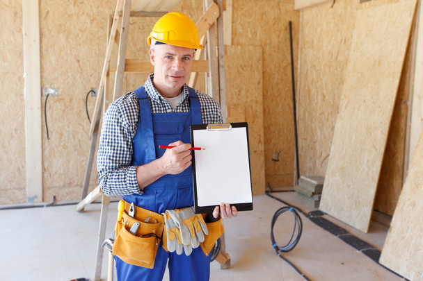 Foreman pointing at folder plate - Photo, Image