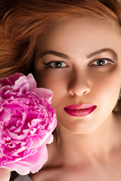 attractive woman with bright makeup with pink peony - Photo, Image