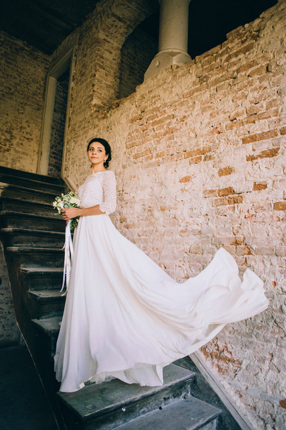 Bride posing on old stairs - Φωτογραφία, εικόνα