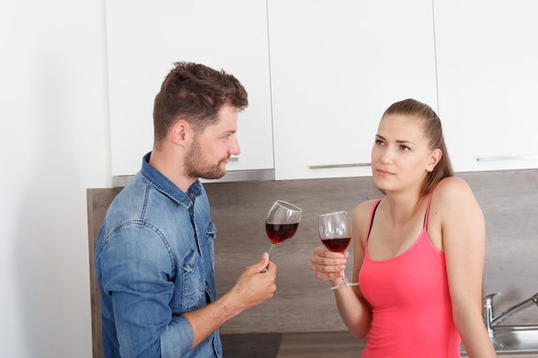 Young couple with a glass of red wine. - 写真・画像