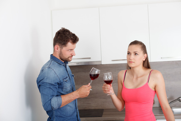 Young couple with a glass of red wine. - Фото, изображение