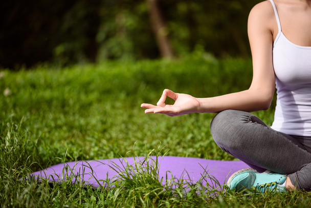 Relaxed woman meditating in park - Photo, Image