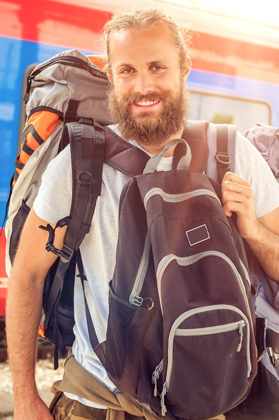 Closeup of handsome tourist traveler standing with huge luggage - Photo, image
