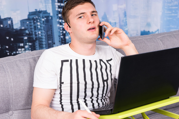 Young bewildered man working from home  - Photo, Image