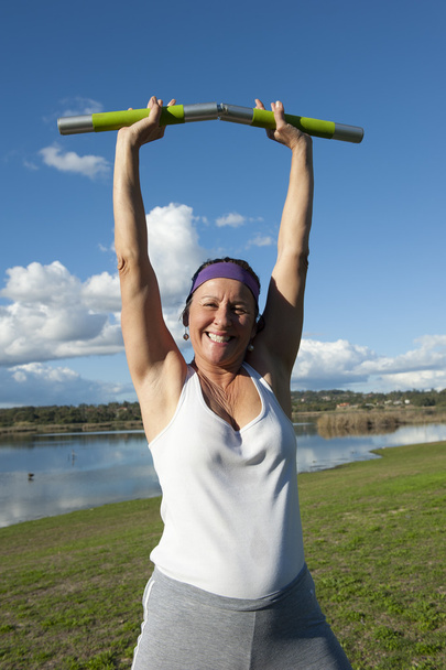 Mature woman exercising with weights - Foto, Imagen