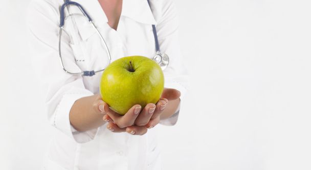doctor  holding  green fresh apple - Фото, зображення