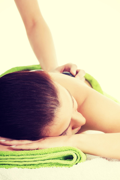 Beautiful woman on spa salon having stone massage. - Foto, Imagem