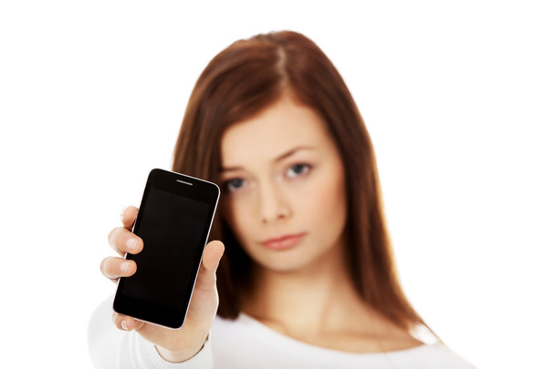 Young sad women showing broken touch screen mobile phone - Photo, image