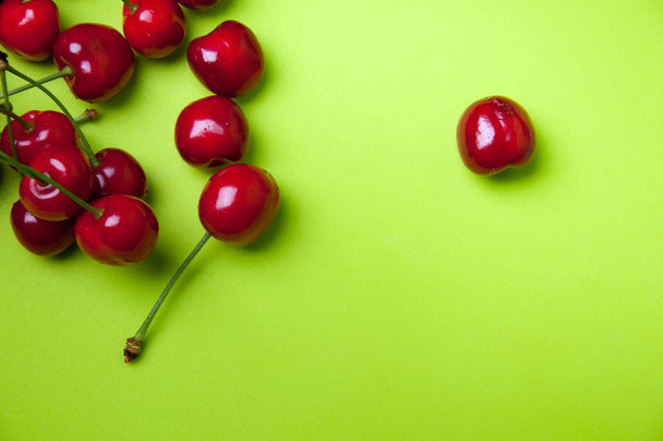 Red sweet cherries on green background - Photo, Image