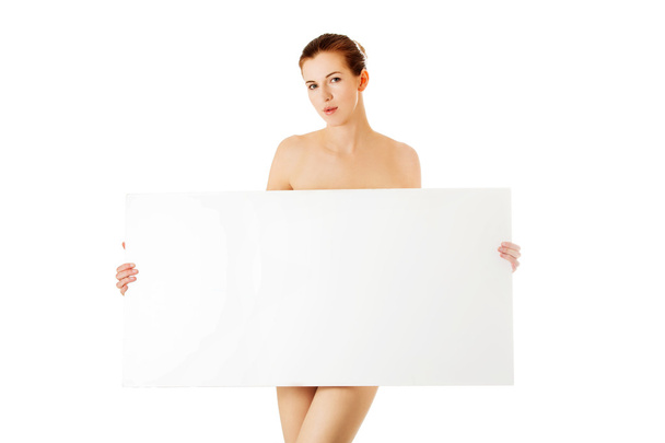 Young woman with empty board. - Zdjęcie, obraz