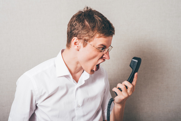 man  shouts into the phone  - 写真・画像
