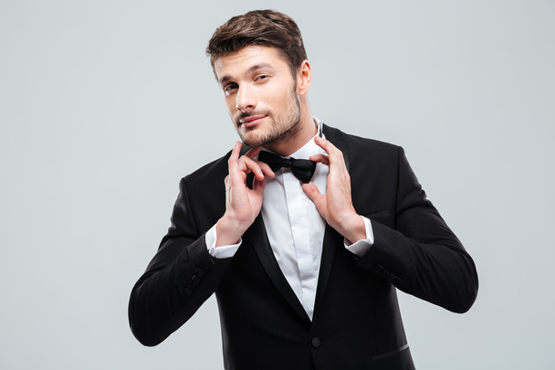 Portrait of handsome young man in tuxedo with bowtie - Fotografie, Obrázek