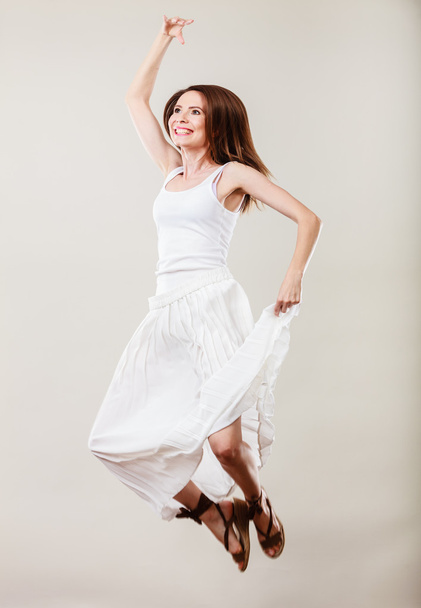Woman in summer white dress jumping - Fotó, kép
