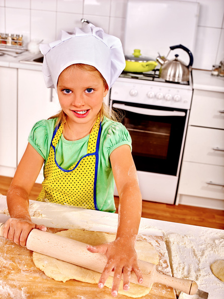 Child cooking dough at kitchen. - Zdjęcie, obraz