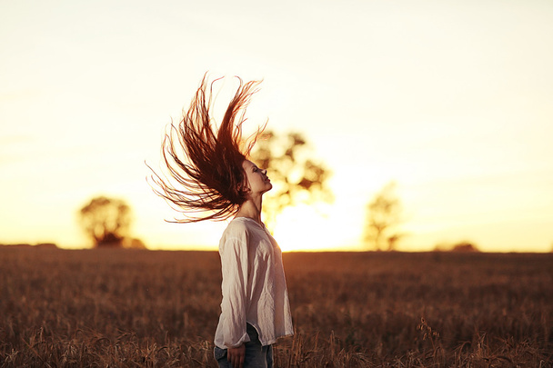 girl with long hair at sunset - Photo, Image