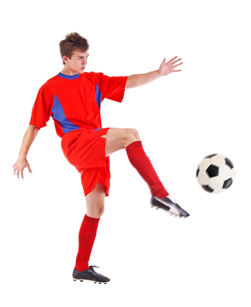 Soccer player kicking the ball - Foto, afbeelding