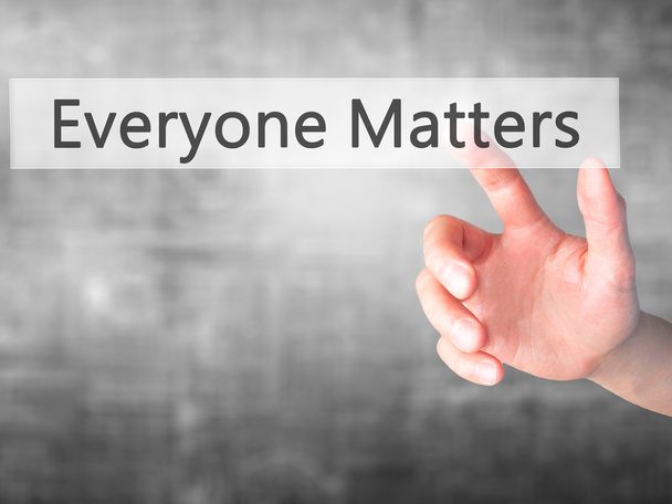 Everyone Matters - Hand pressing a button on blurred background  - Photo, Image