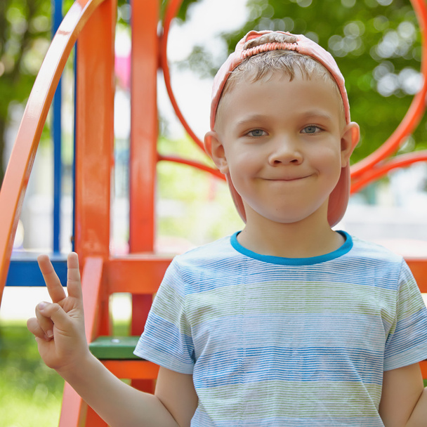 Adorable boy portrait in the playground - Фото, изображение