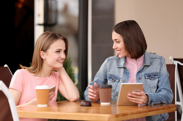 Young happy women drinking coffee - Fotografie, Obrázek