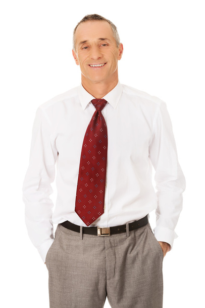 Smiling businessman with hands in pockets - Photo, Image