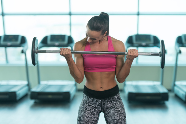 Young Woman Doing Biceps Exercise With Barbell - Photo, Image