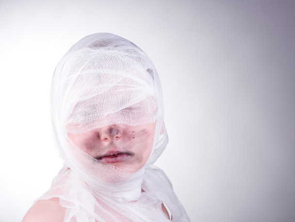 Teenager boy with Mummy bandages on Halloween - 写真・画像